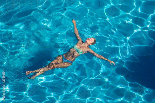 Woman swims in the pool outdoor. People  summer and holiday concept