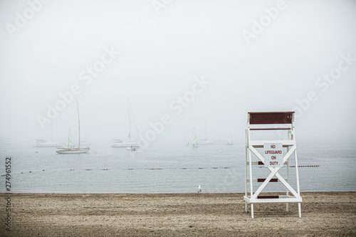 Foggy day at the beach with lifeguard chair