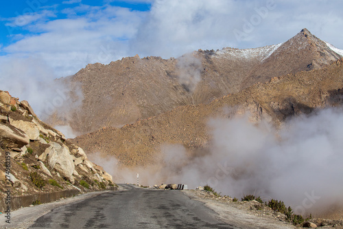 View of winding road and majestic rocky mountains in Indian Himalayas, Ladakh, India. Nature and travel concept