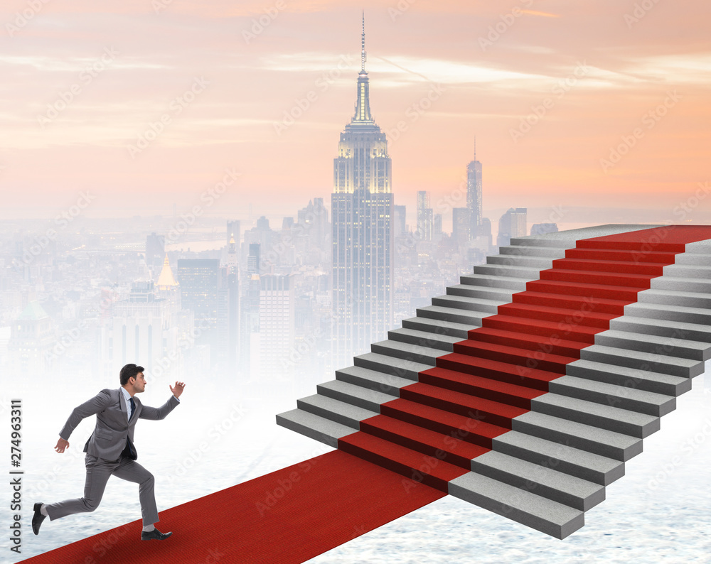 Young businessman climbing stairs and red carpet Young businessman climbing stairs and red carpet