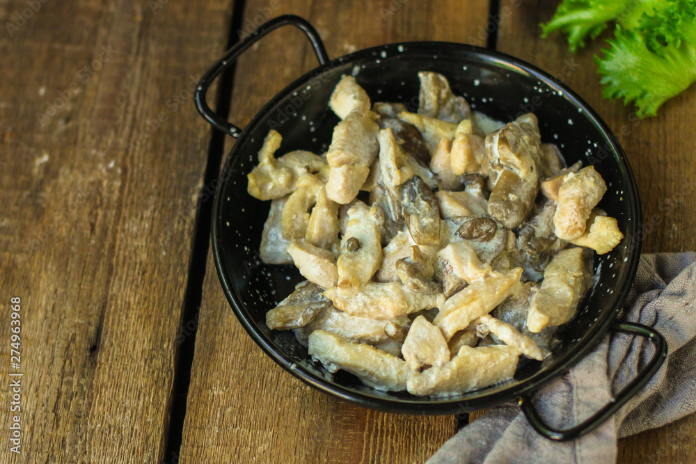 chicken meat with mushrooms in a creamy sauce - snacks. healthy food and menu. copy space chicken meat with mushrooms in a creamy sauce - snacks. healthy food and menu. copy space