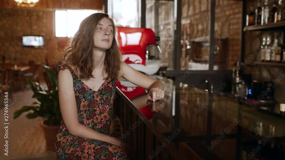 Beautiful sad woman in dress, sitting alone in bar, waiting for someone. 4k Handheld Beautiful sad woman in dress, sitting alone in bar, waiting for someone. 4k Handheld