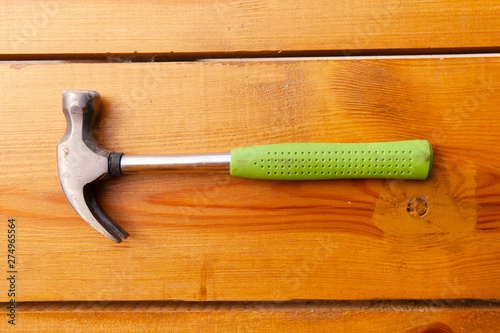 A hammer is laying on a wooden surface