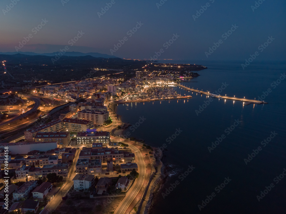 Night view of L'Ampolla, Catalonia, Spain. Drone aerial photo