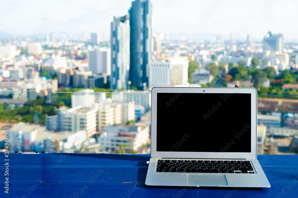 The computer is on the table near the panoramic window with a beautiful panoramic view The computer is on the table near the panoramic window with a beautiful panoramic view