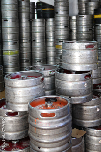 Large metal barrels or containers for beer in industrial production. Kegs for beers of different colors in stock. The concept of production.
