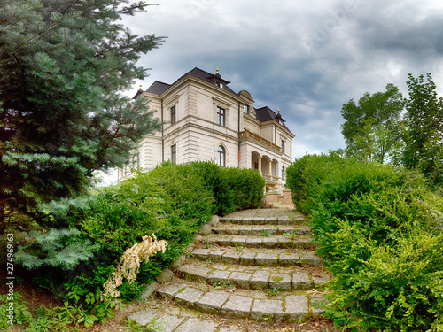 WROCLAW, POLAND - JUNE 21, 2019: Palace in Biskupice Podgorne near Wroclaw, Poland. Cloudy sky on the last day of spring. photo