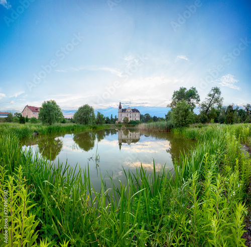 WROCLAW, POLAND - JUNE 21, 2019: Palace in Biskupice Podgorne near Wroclaw, Poland. Cloudy sky on the last day of spring. photo