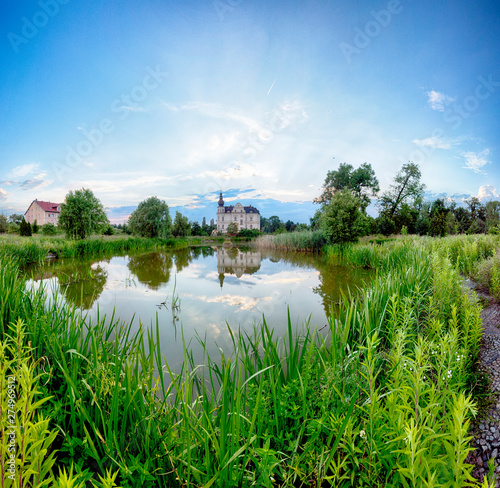 WROCLAW, POLAND - JUNE 21, 2019: Palace in Biskupice Podgorne near Wroclaw, Poland. Cloudy sky on the last day of spring. photo