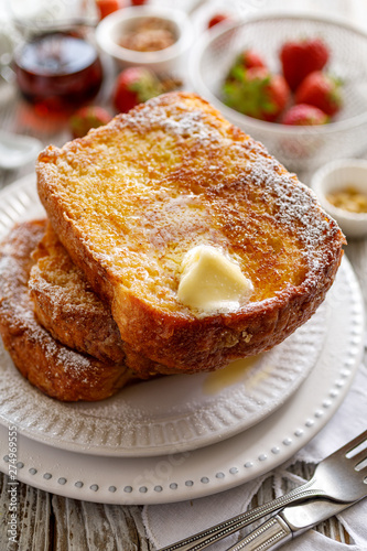 French toast, warm French toast made of sliced brioche with fresh butter, sprinkled with powdered sugar. Delicious, traditional breakfast