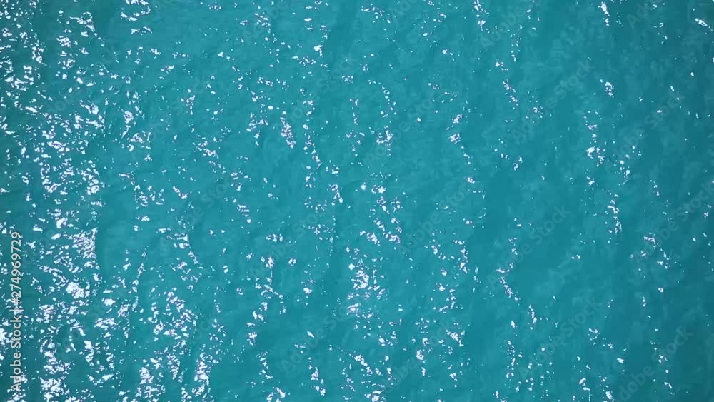 Turquoise colored waves ripple and roll at the surface. Segment 2 of 3, part of a larger clip that is segmented, but when put all together is a more robust clip in slow motion Turquoise colored waves ripple and roll at the surface. Segment 2 of 3, part of a larger clip that is segmented, but when put all together is a more robust clip in slow motion