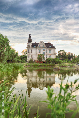 WROCLAW, POLAND - JUNE 21, 2019: Palace in Biskupice Podgorne near Wroclaw, Poland. Cloudy sky on the last day of spring. photo