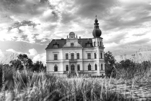 WROCLAW, POLAND - JUNE 21, 2019: Palace in Biskupice Podgorne near Wroclaw, Poland. Cloudy sky on the last day of spring. photo