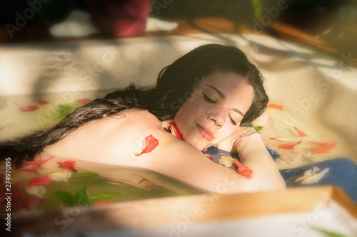 Girl taking the herbal bath and basking in the sun