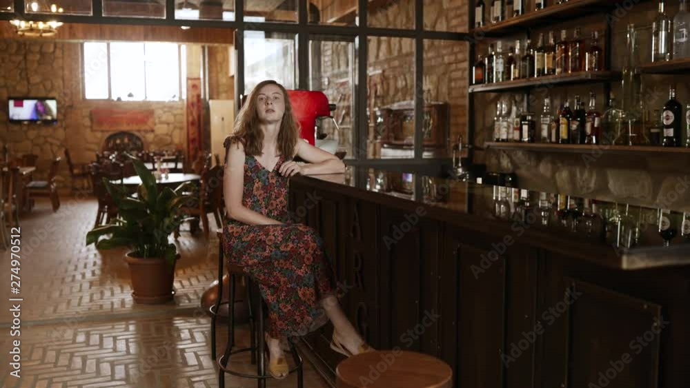 Unhappy woman waiting for someone sitting in bar. 4k handheld Unhappy woman waiting for someone sitting in bar. 4k handheld