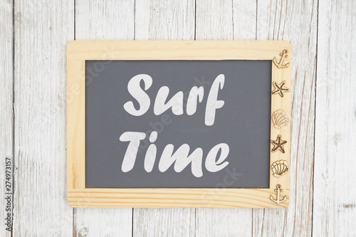 Surf time text on a chalkboard with nautical objects © Karen Roach