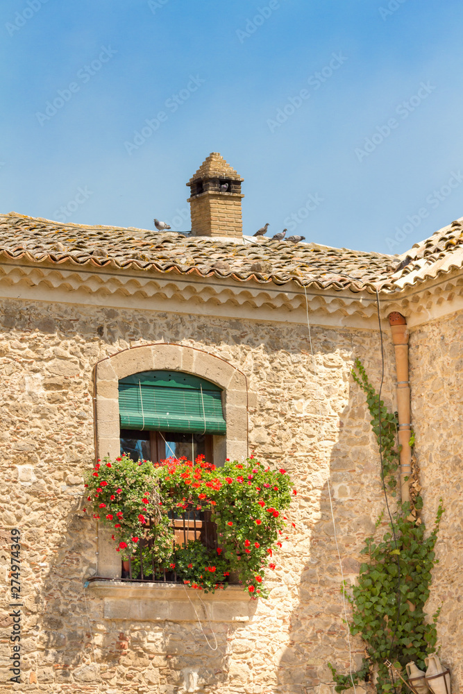 Italian Villa Balcony House with Red Flowers and Ivy