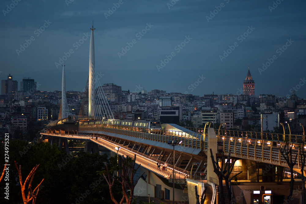Night view of the metro bridge through the Golden Horn and the Galata Tower in Istanbul, Turkey