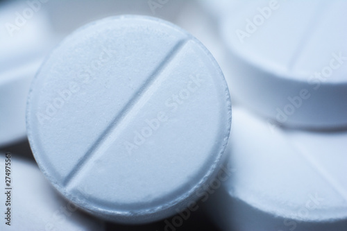 Pills in a white color. Macro details of tablets. Close up. Cfn use as background in medicene.