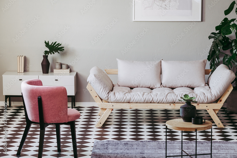Pastel pink chair in beige and grey living room interior - obrazy, fototapety, plakaty 