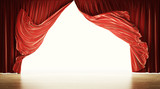 Empty theatrical stage with moving red velvet curtains. Clipping path included.