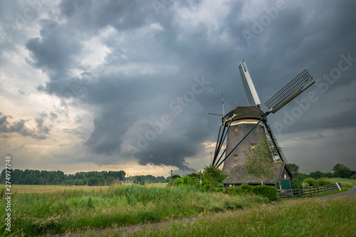 Traditional windmill in Holland under a stormy sky