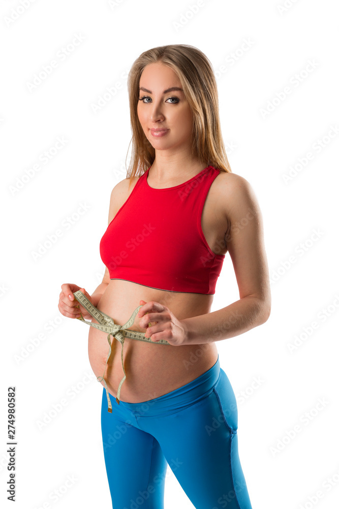 beautiful young pregnant woman measuring belly on white background beautiful young pregnant woman measuring belly on white background
