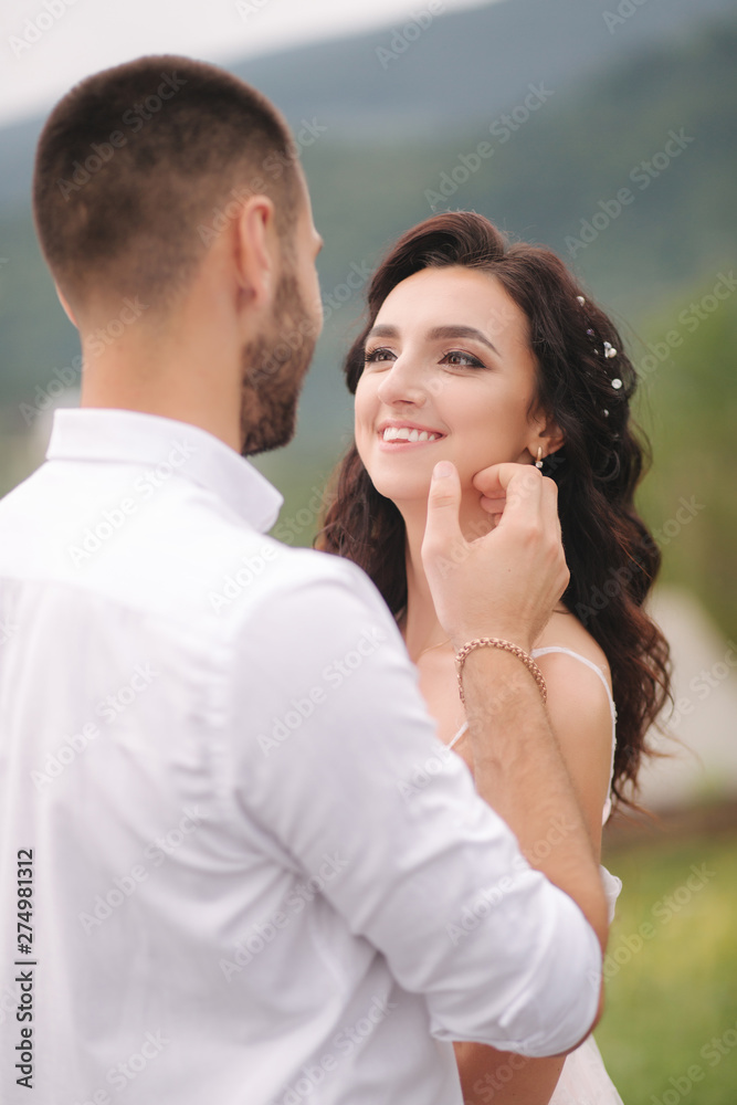 Close up portrait of beautiful couple in mountains. Happy woman with man. Elegant female with her husband Close up portrait of beautiful couple in mountains. Happy woman with man. Elegant female with her husband