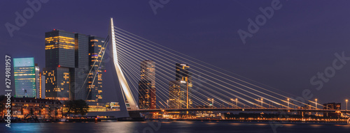 Night panoramic cityscape of Rotterdam, Netherlands. Erasmusbrug and business district skyscrapers in the background photo