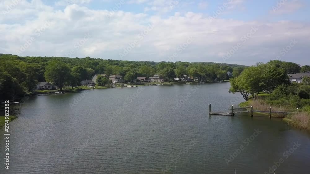 Aerial view residential homes line narrow river bank in Rhode Island Aerial view residential homes line narrow river bank in Rhode Island