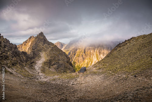 Mountain Landscape with Cottage under Rysy Peak as Seen from Sedlo Vaha at Sunrise with Golden Light in High Tatras, Slovakia photo