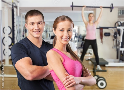 Man and woman in gym exercising together