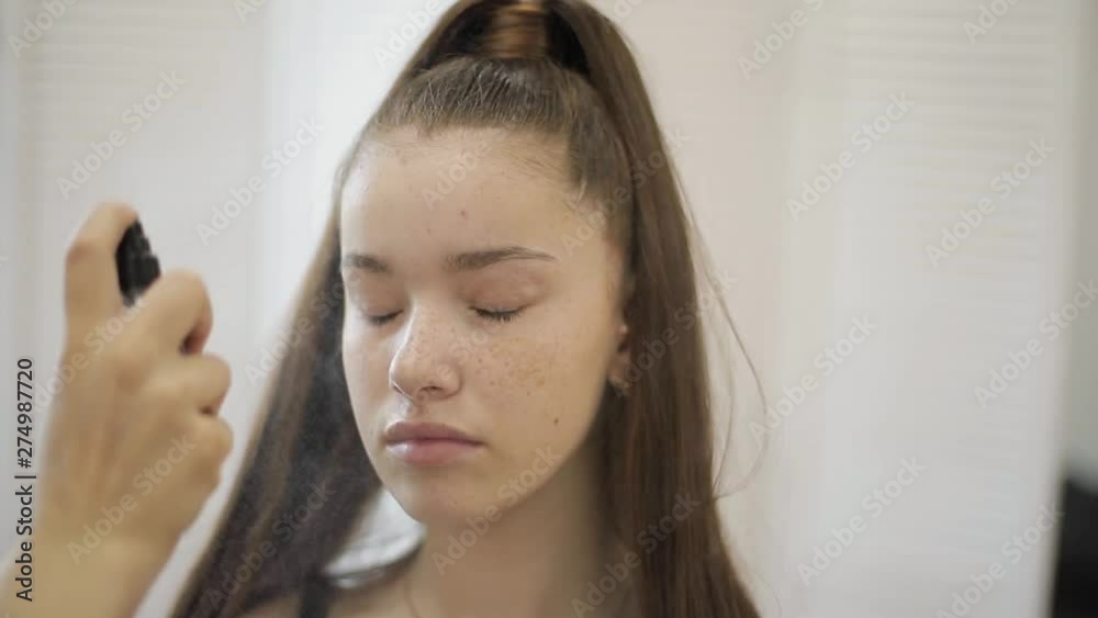 Makeup artist work with model in beauty studio. Fashion make for elegant redhead model without makeup. Start Makeup artist work with model in beauty studio. Fashion make for elegant redhead model without makeup. Start