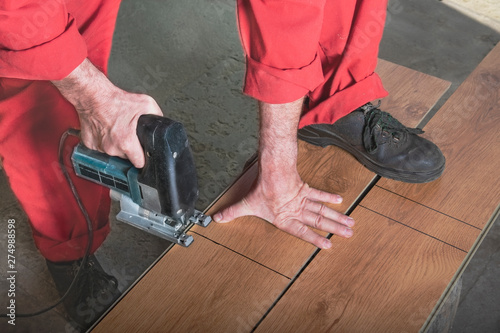 Master saws the bar with an electric saw