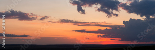 Leaden, storm clouds covered the sunset. Cumuliform cloudscape on blue sky. The terrain in southern Europe. Fantastic skies on the planet earth. Tragic gloomy sky.