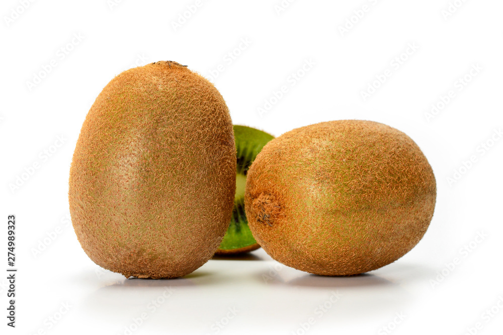 Two fresh ripe whole kiwi fruits isolated on white background with shadows, closeup. Two fresh ripe whole kiwi fruits isolated on white background with shadows, closeup.
