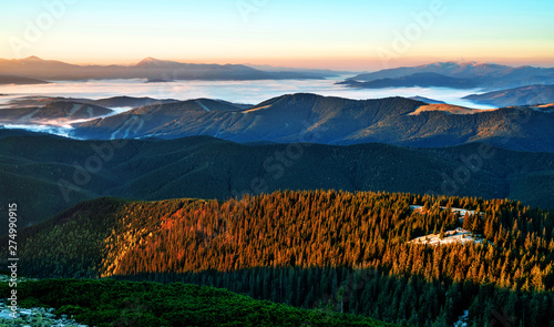 Beautiful dawn in the mountain range. Mountains shrouded in mist in a scenic landscape view. Location Carpathian mountains, Europe. Travel background