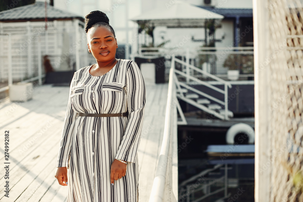 Black girl. Woman in a white dress. Lady on the pier Black girl. Woman in a white dress. Lady on the pier