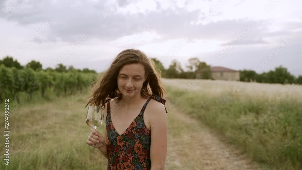 Woman drinking white wine at vineyard from wine glass outdoors. Woman drinking white wine at vineyard from wine glass outdoors.