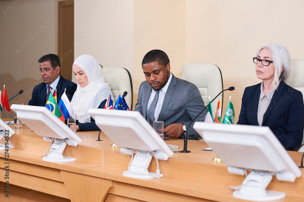 Fototapeta premium Row of contemporary young and mature intercultural politicians