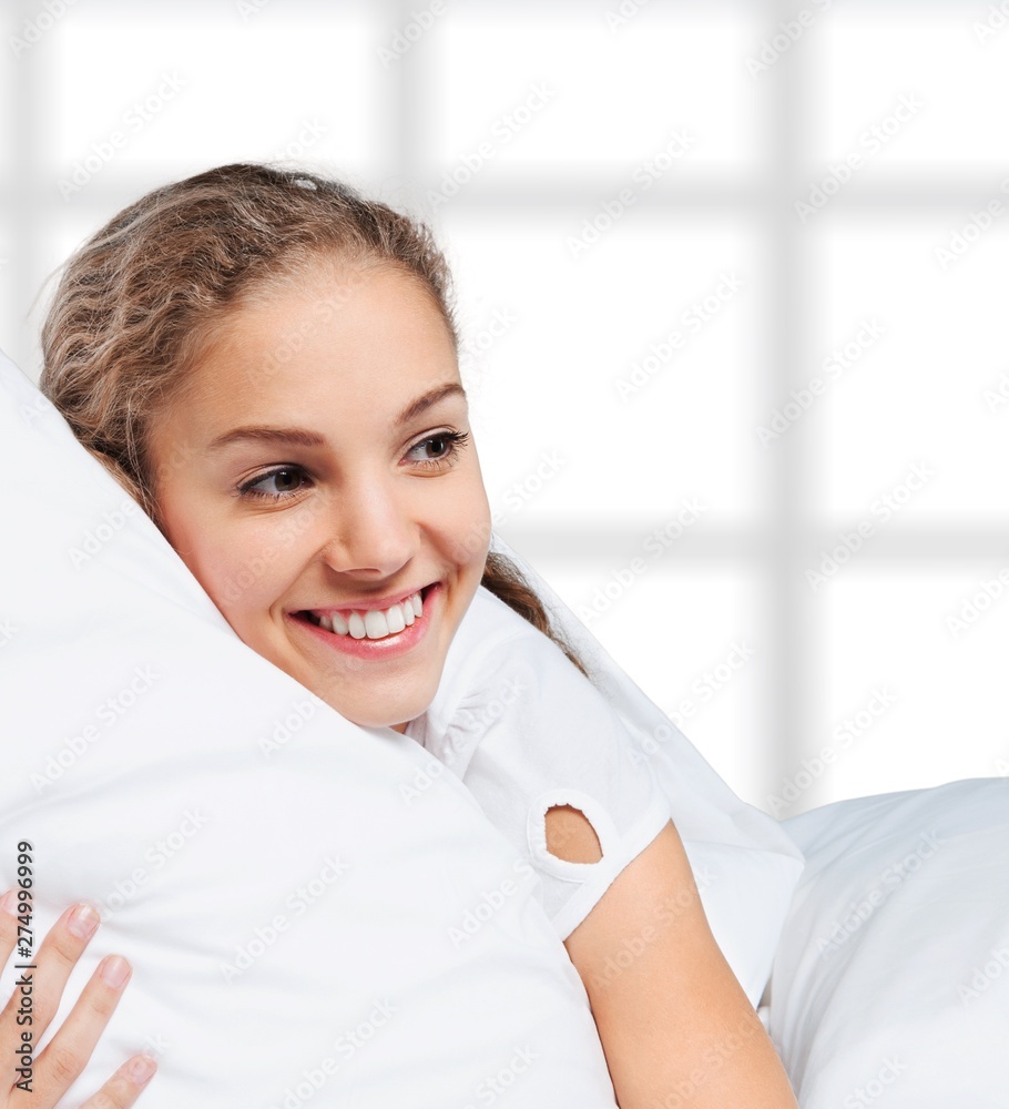 Young woman wakeup after sleeping on the white linen in bed at home Young woman wakeup after sleeping on the white linen in bed at home