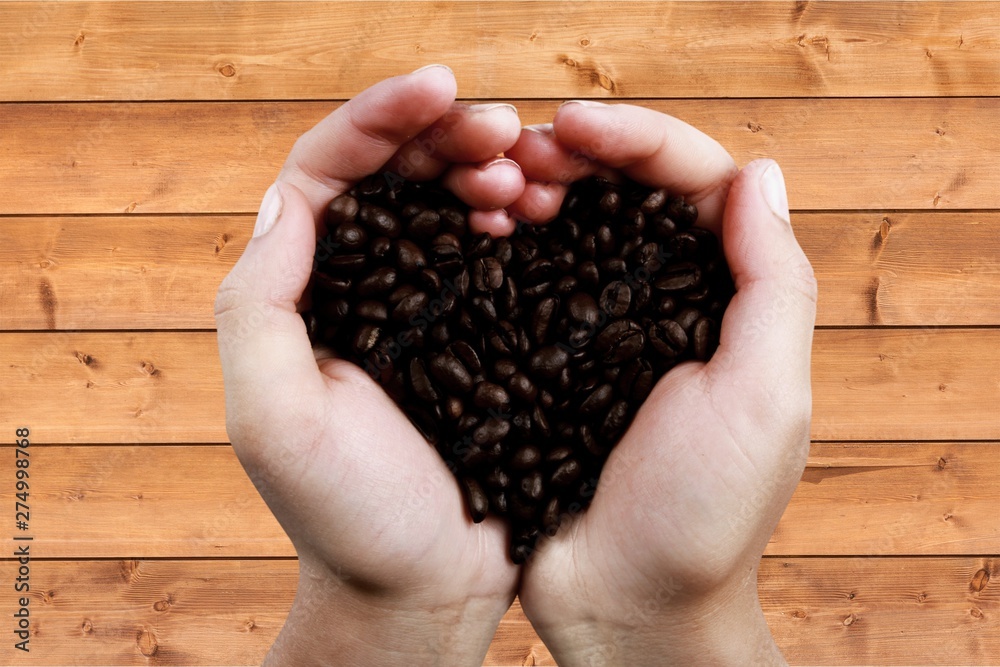 Coffee cup and coffee beans on wooden background Coffee cup and coffee beans on wooden background