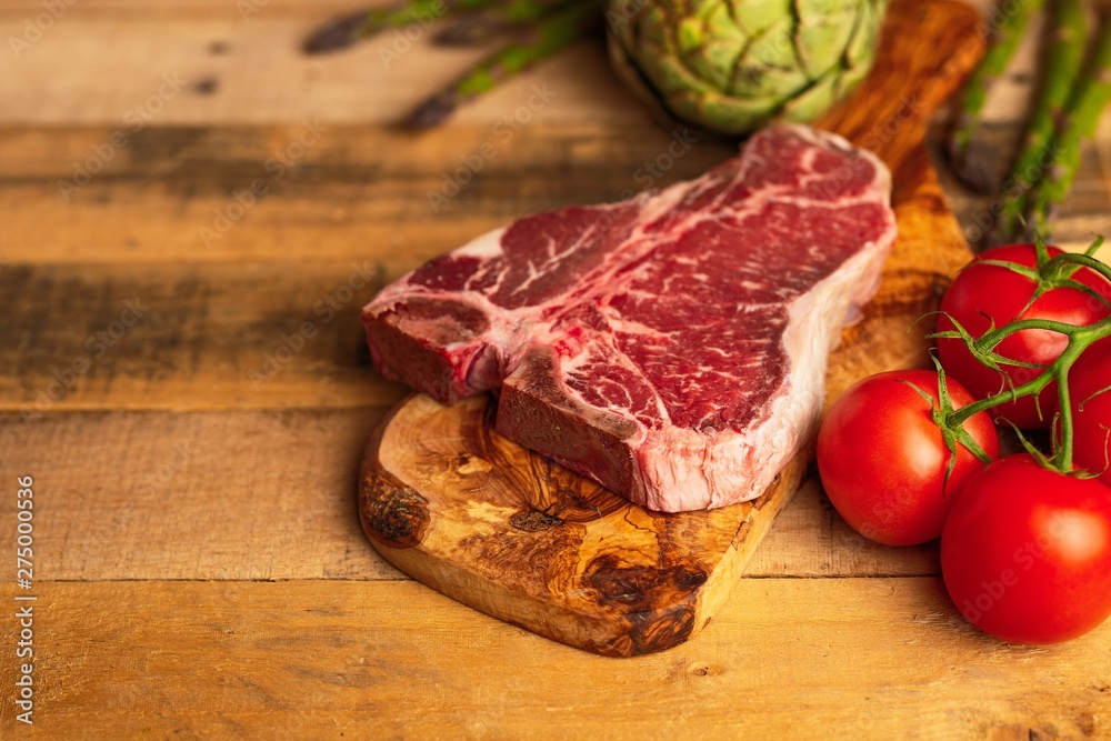 Juicy fresh piece of marbled beef steak with vegetables for grilling. Culinary background, recipe book, delicious food, Steak cooking. With space, horizontal photo Juicy fresh piece of marbled beef steak with vegetables for grilling. Culinary background, recipe book, delicious food, Steak cooking. With space, horizontal photo