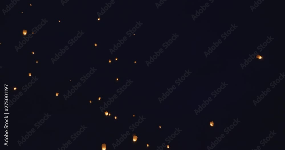 Floating lanterns on dark sky