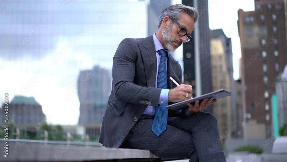 Concentrated proud ceo in formal wear searching information for project using pen stylus on touch pad, experienced finance manager using app on digital tablet for working with budget accounting 