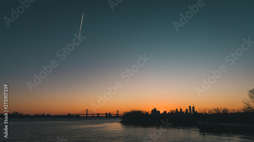 Sunset over philadelphia skyline with airplane streat photo