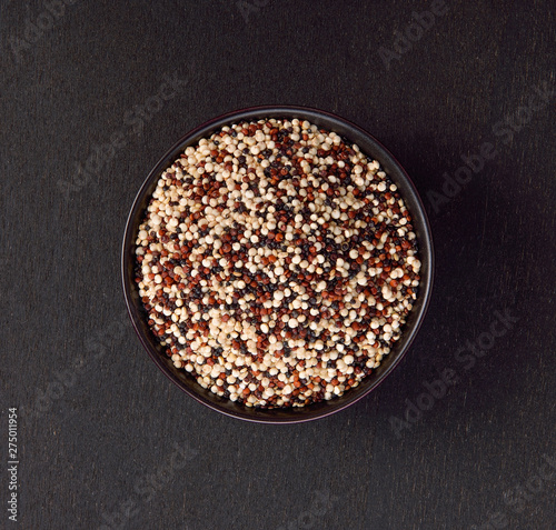 quinoa seeds on black wooden background
