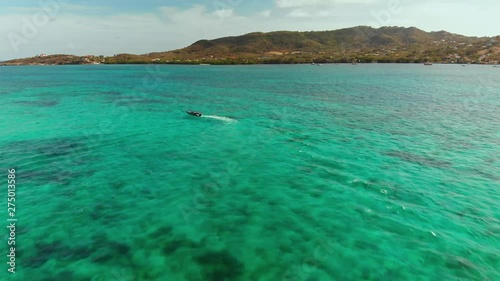 Bird's eye view of a speed boat heading to the Caribbean island Carriacou photo