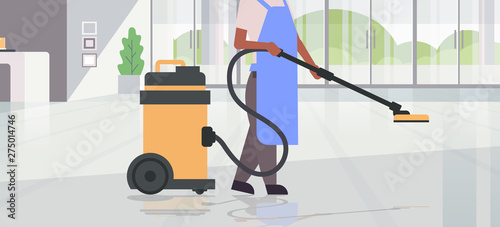 woman using professional vacuum cleaner african american female cleaner janitor in uniform cleaning service floor care concept modern hotel lobby hall interior horizontal flat closeup portrait