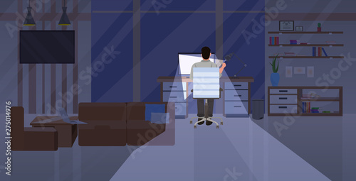 tired man sitting at workplace rear view businessman working on computer at night deadline overwork concept modern office interior flat horizontal